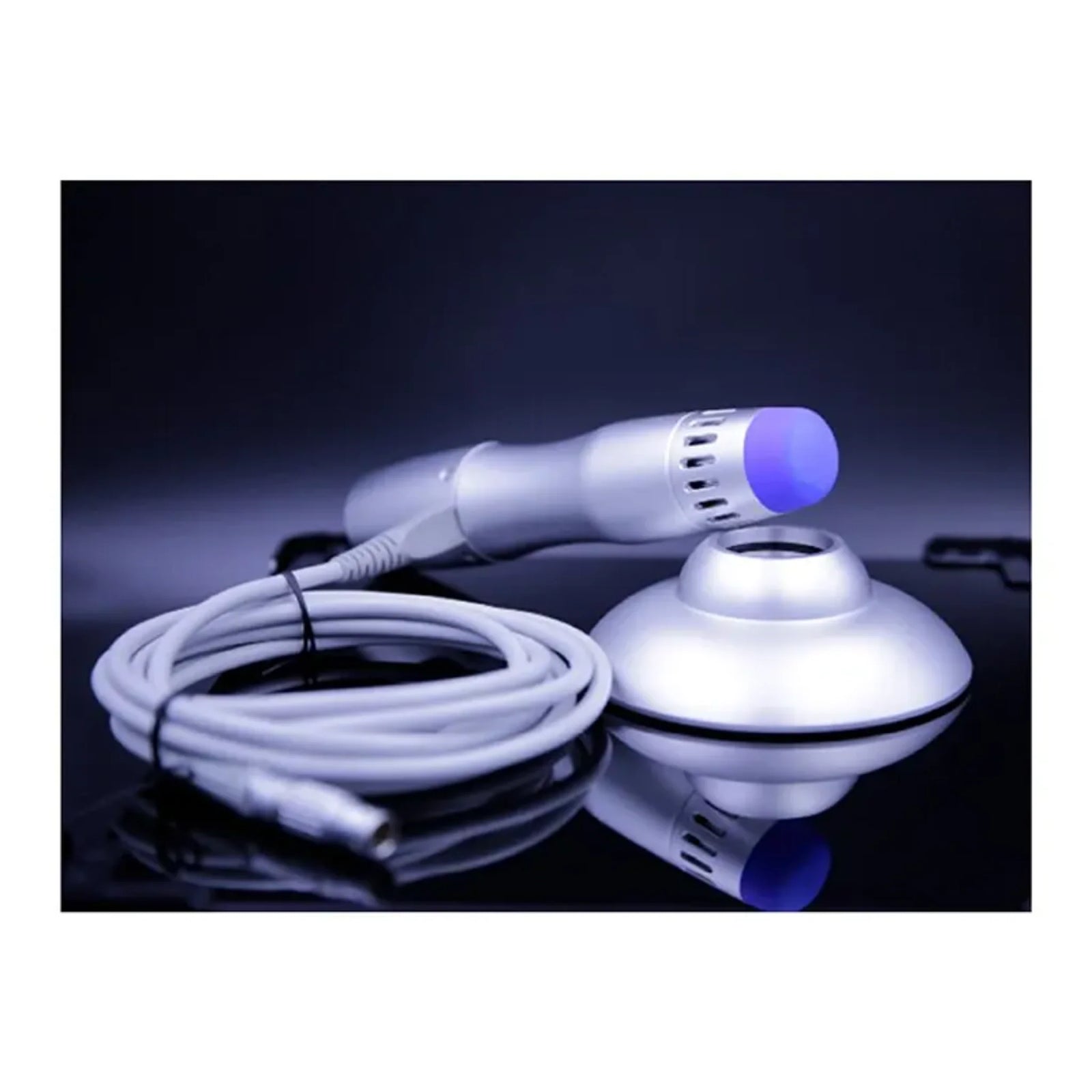 PhysioPRO handpiece with applicator head and cable resting on a handle pedestal