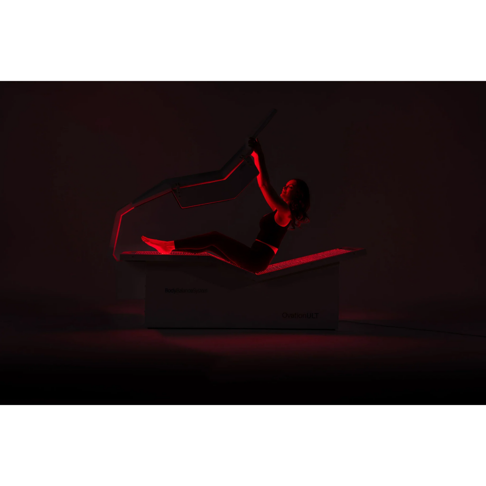 Body Balance System OvationULT Zero Gravity Red & Infrared Light Bed – person lying in the bed under red light