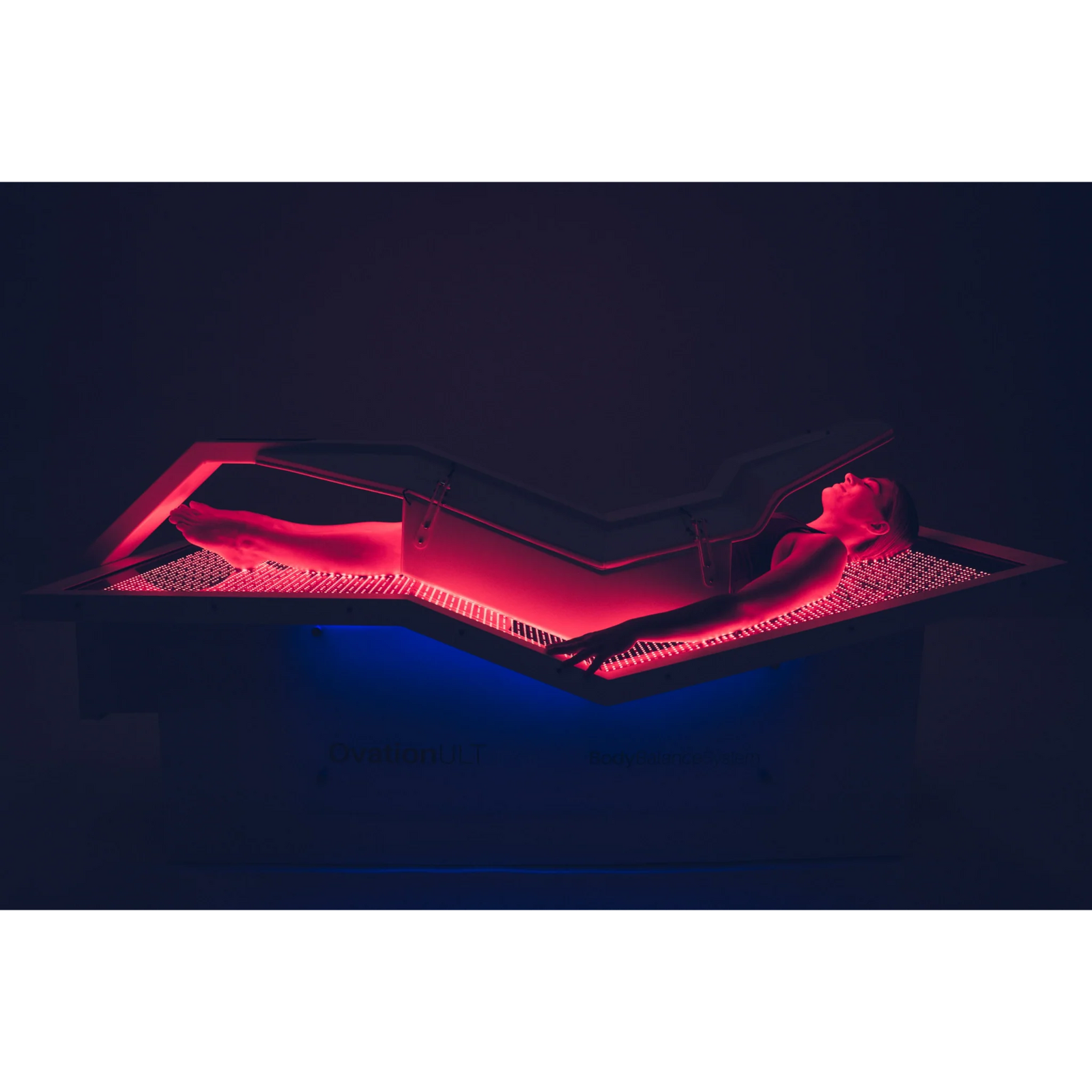 Body Balance System OvationULT Zero Gravity Red & Infrared Light Bed – person lying in the bed with red and blue light