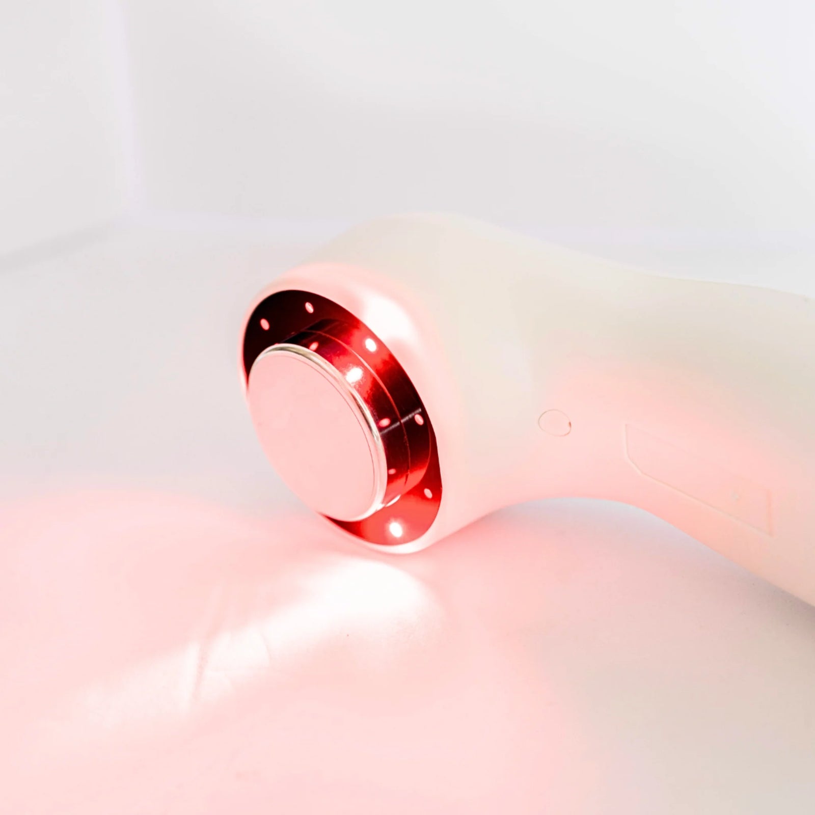 Lasonic handheld ultrasound and laser device with red light ring around the applicator face, side view