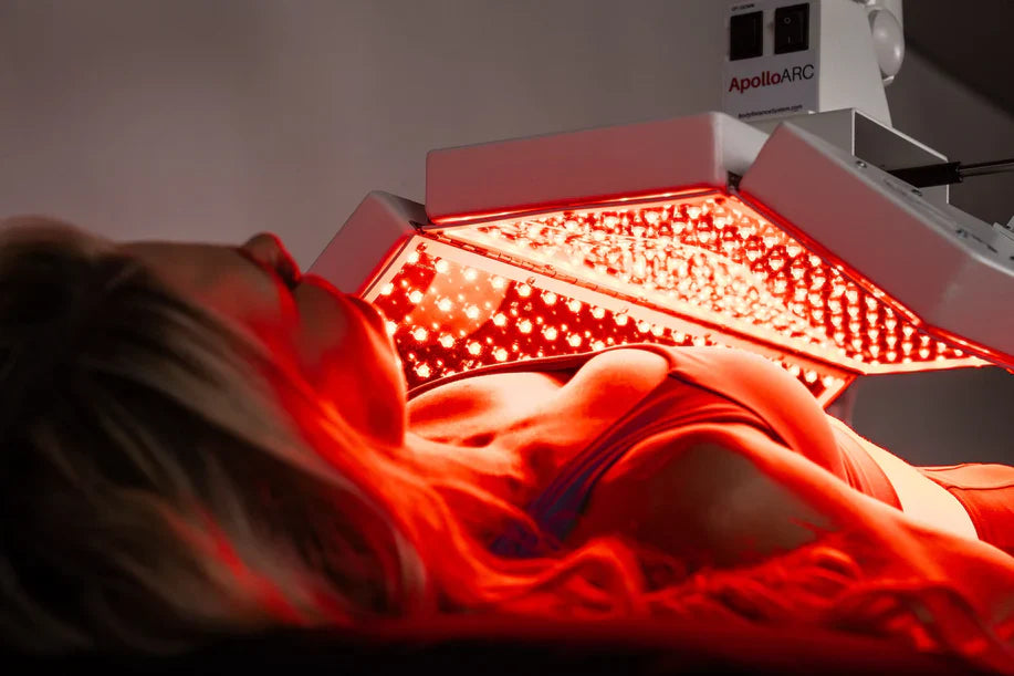 Close-up of woman using ApolloARC red light therapy canopy during session