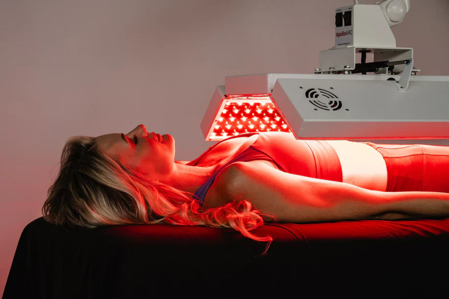 Woman receiving red light therapy under the ApolloARC canopy by Body Balance System