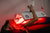Woman receiving red light therapy with ApolloARC panel emitting visible red glow