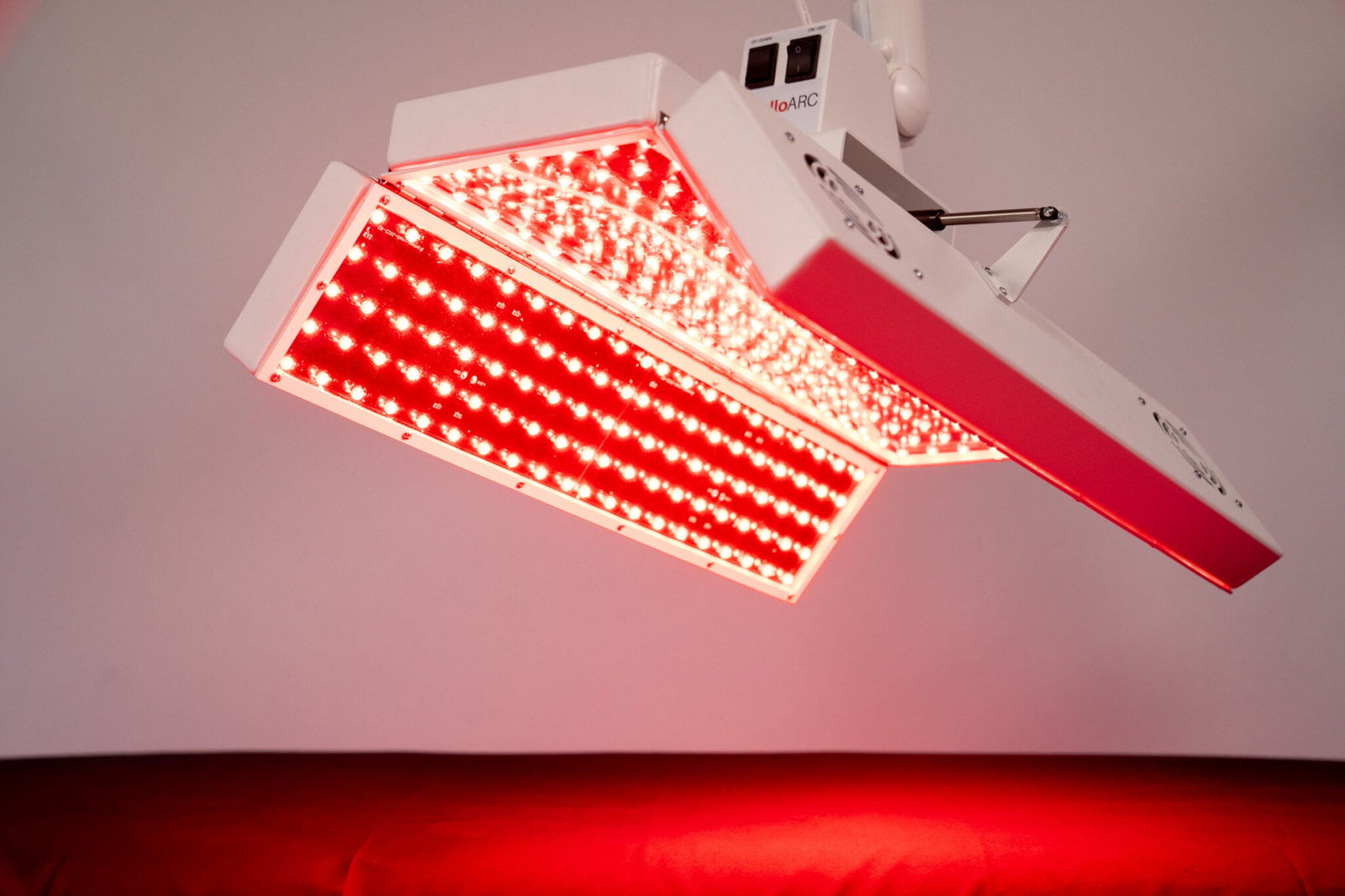 Close-up of ApolloARC red light therapy panel with LEDs fully illuminated