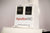 ApolloARC red light therapy panel glowing over red treatment bed with adjustable arm