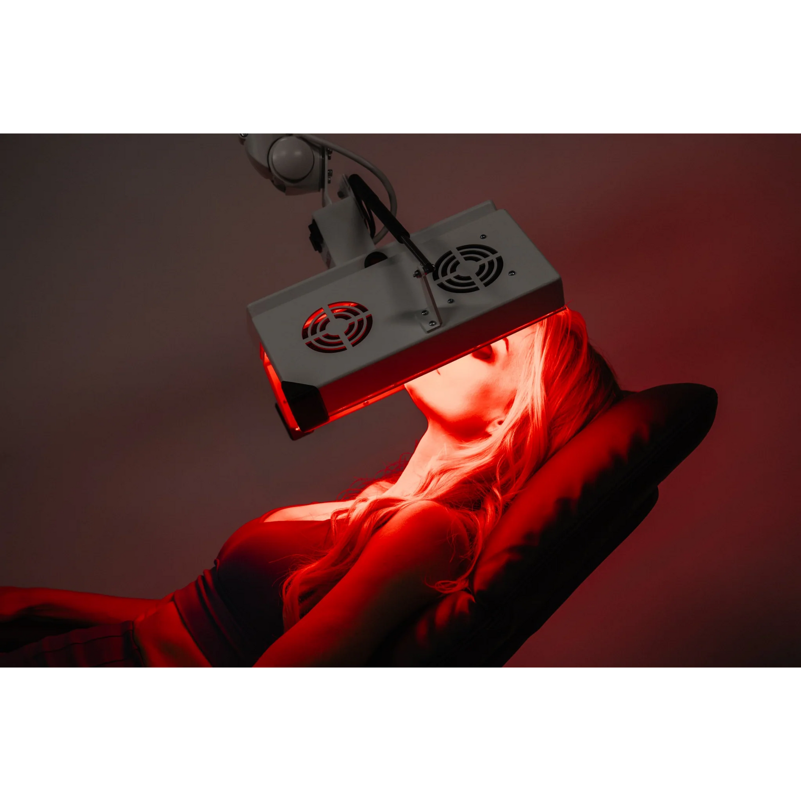 Body Balance System ApolloGLOW Red & Infrared Light Panel – red light panel with a fan close to a woman's face