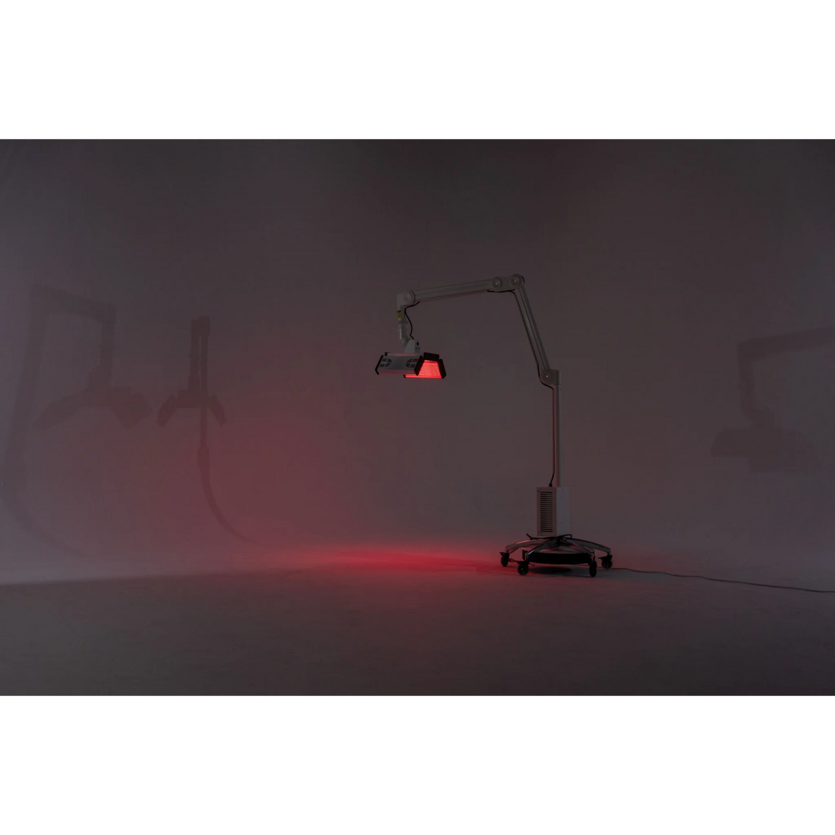 Body Balance System ApolloGLOW Red & Infrared Light Panel – stand and light panel glowing red in a dark room