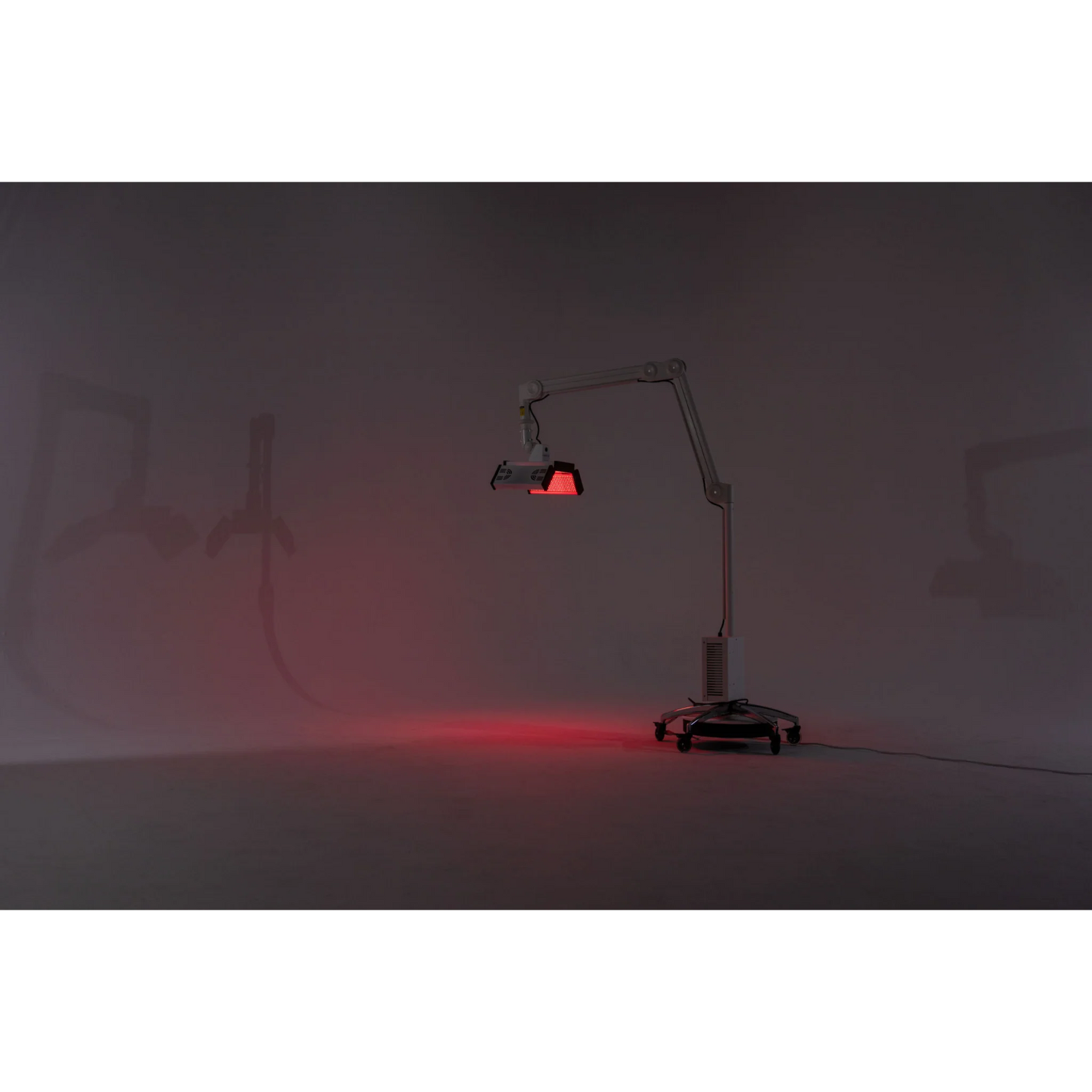 Body Balance System ApolloGLOW Red & Infrared Light Panel – stand and light panel glowing red in a dark room