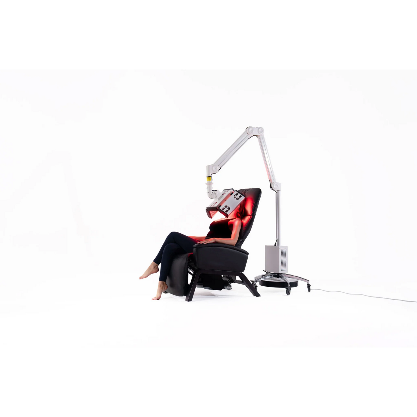 Body Balance System ApolloGLOW Red & Infrared Light Panel – woman seated in a recliner with the light panel overhead