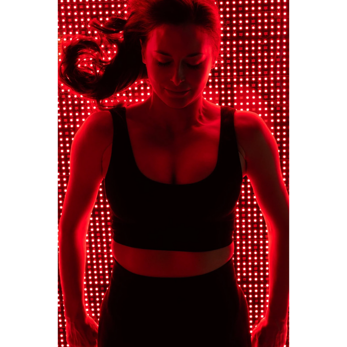 Body Balance System OvationLITE Zero Gravity Red & Infrared Light Bed – woman standing over the red LED bed