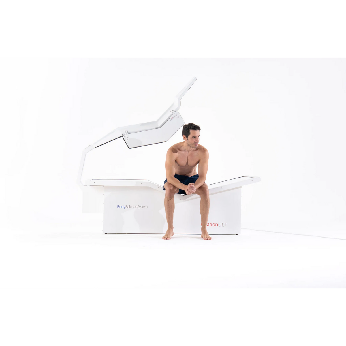 Body Balance System OvationULT Zero Gravity Red & Infrared Light Bed – man sitting on the bed