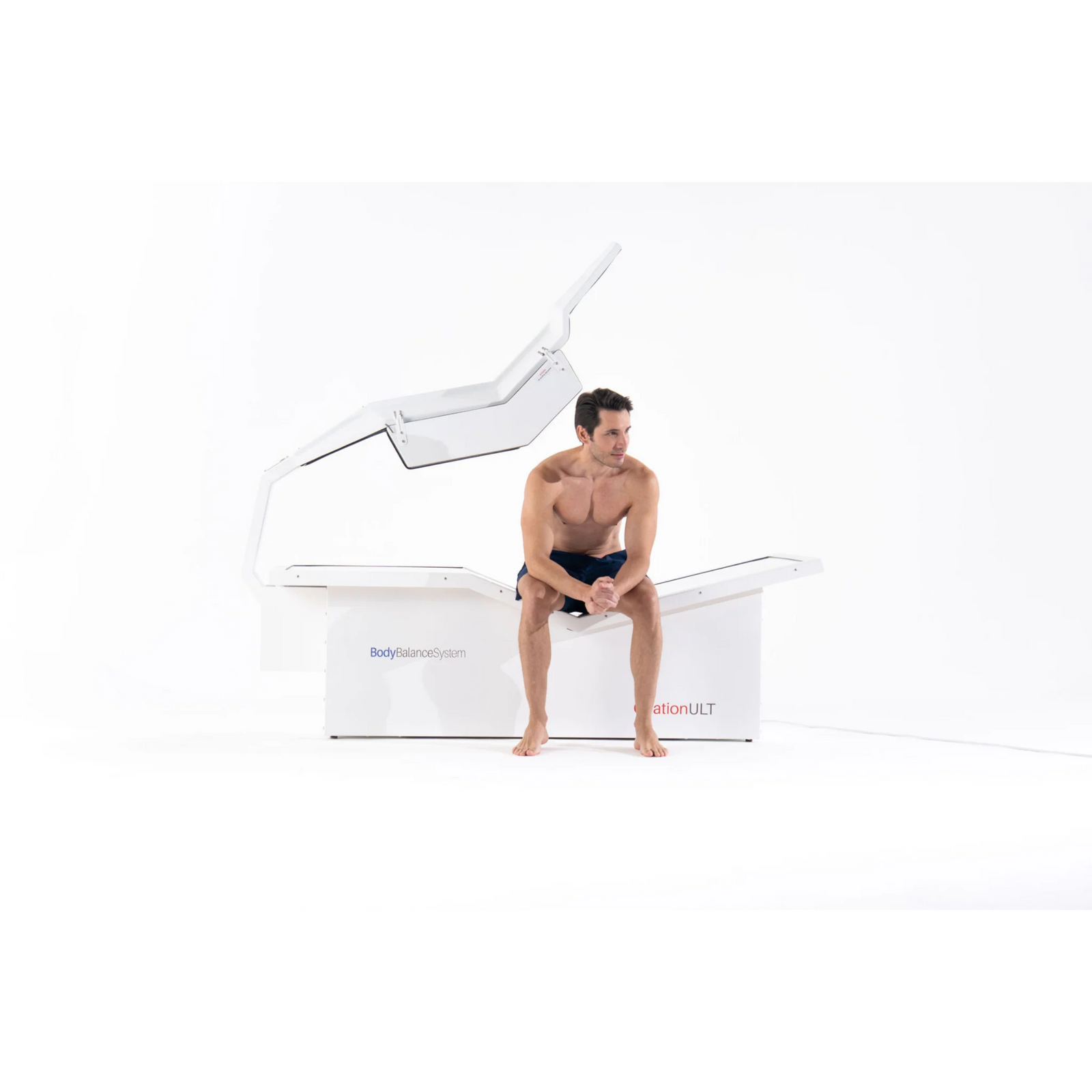 Body Balance System OvationULT Zero Gravity Red & Infrared Light Bed – man sitting on the bed
