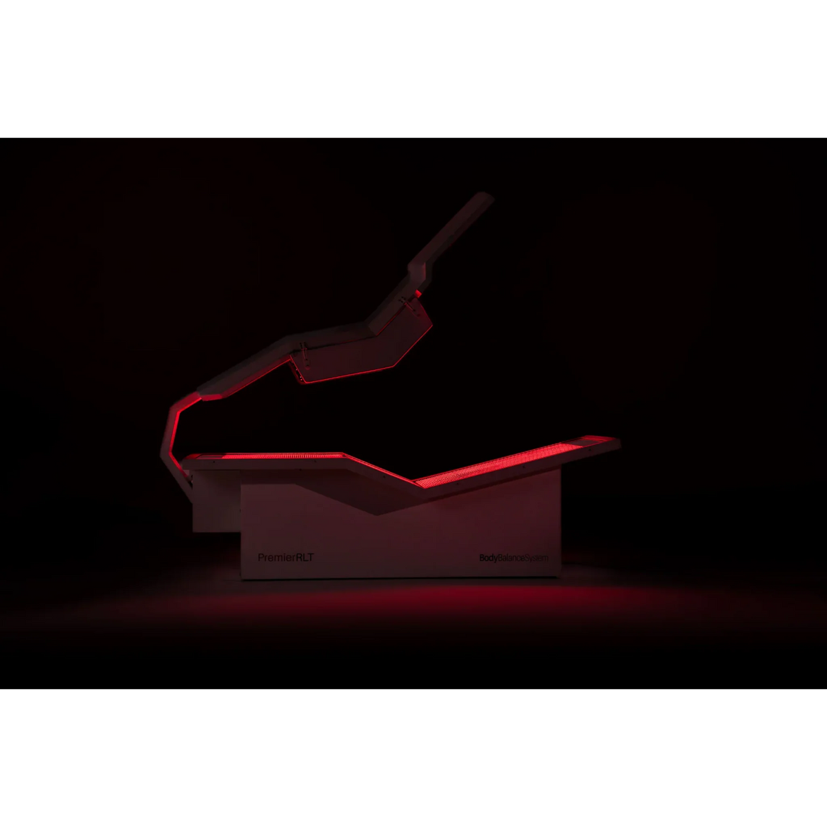 Body Balance System PremierRLT Zero Gravity Red & Infrared Light Bed – bed glowing red in a dark room