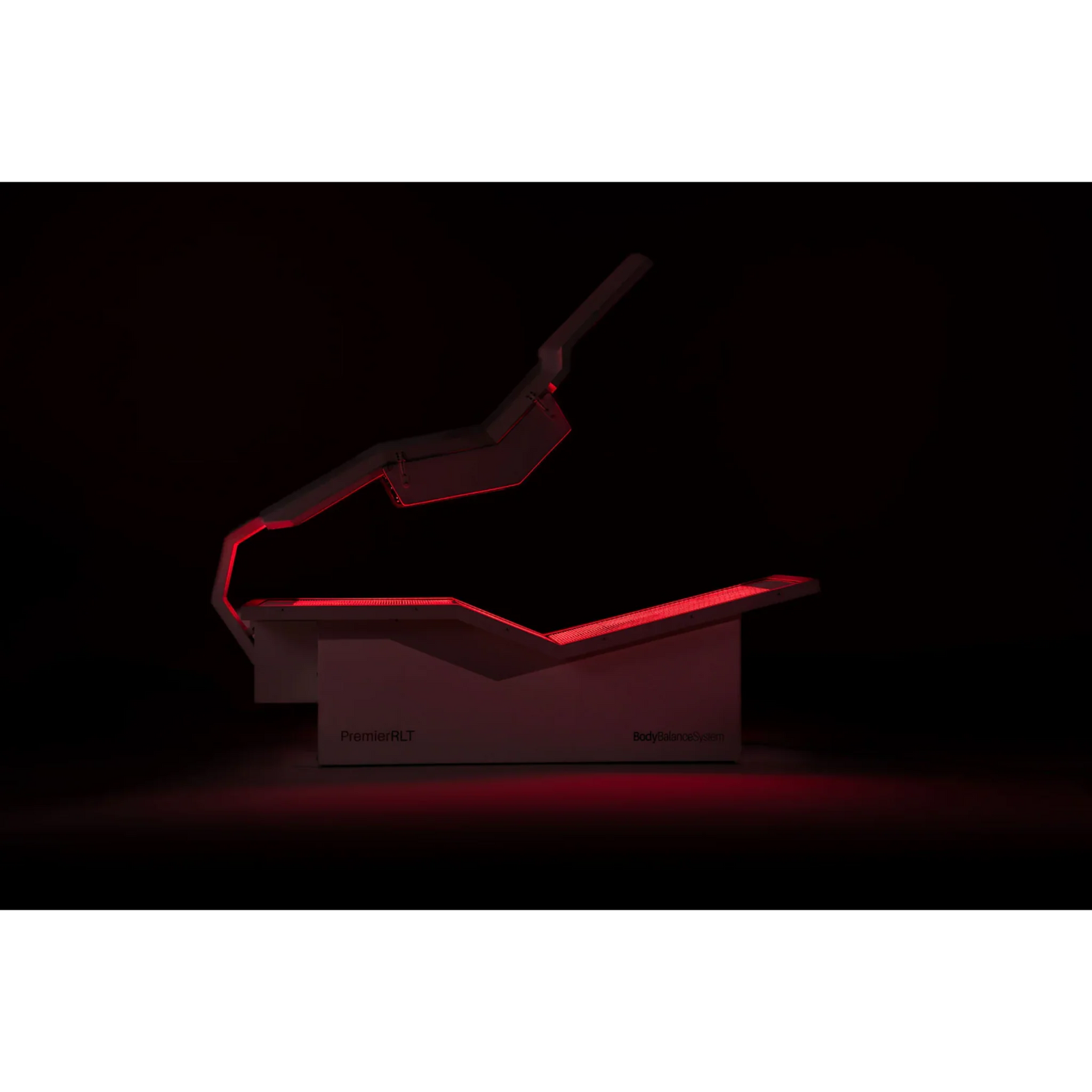 Body Balance System PremierRLT Zero Gravity Red & Infrared Light Bed – bed glowing red in a dark room