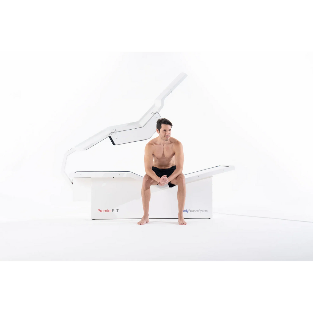 Body Balance System PremierRLT Zero Gravity Red & Infrared Light Bed – man sitting on the bed