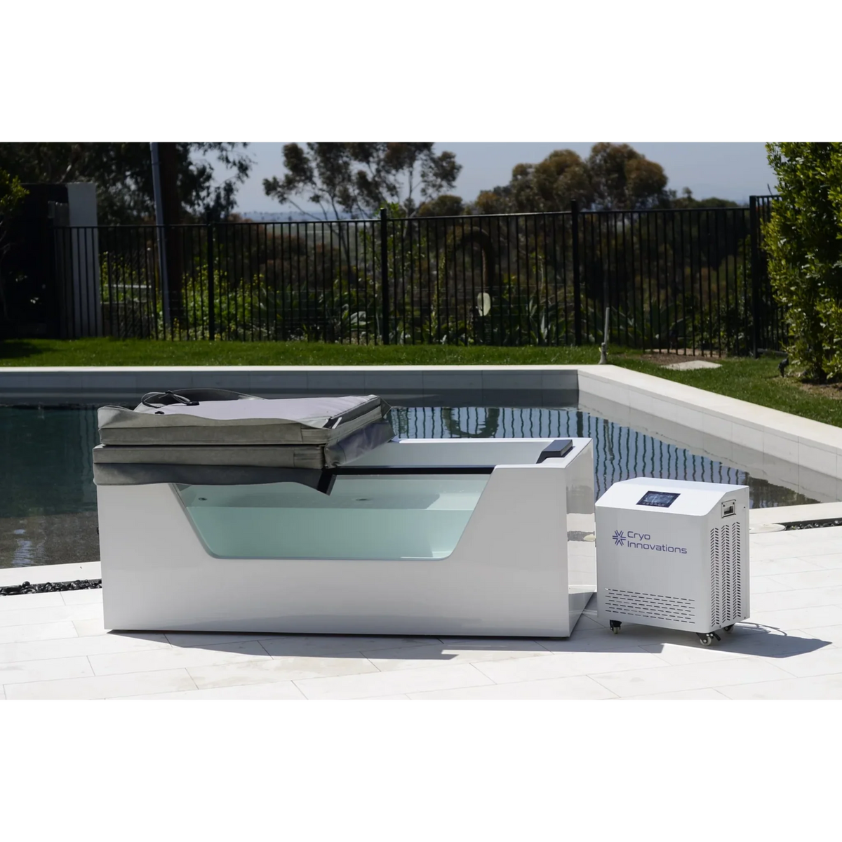 Cryo Innovations XR Cryo Plunge with Window – tub with an insulated cover beside a pool