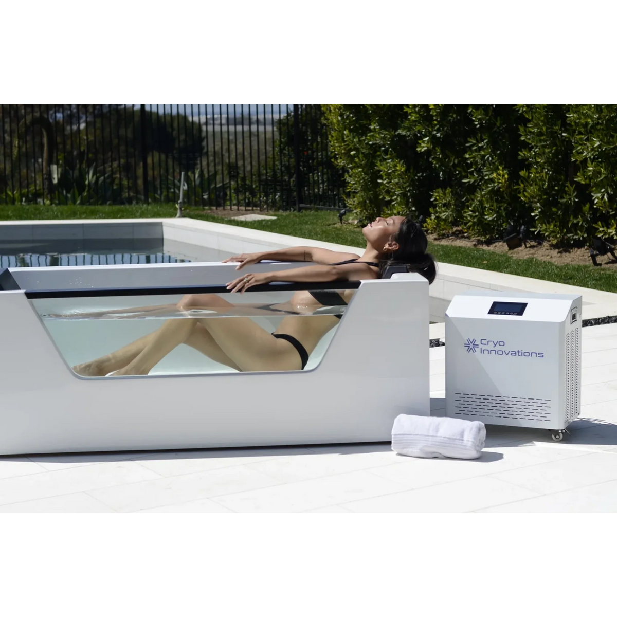 Cryo Innovations XR Cryo Plunge with Window – woman relaxing in the tub by a pool