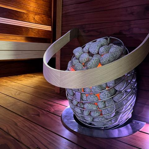 HUUM Drop 7.5kW electric sauna heater, glowing