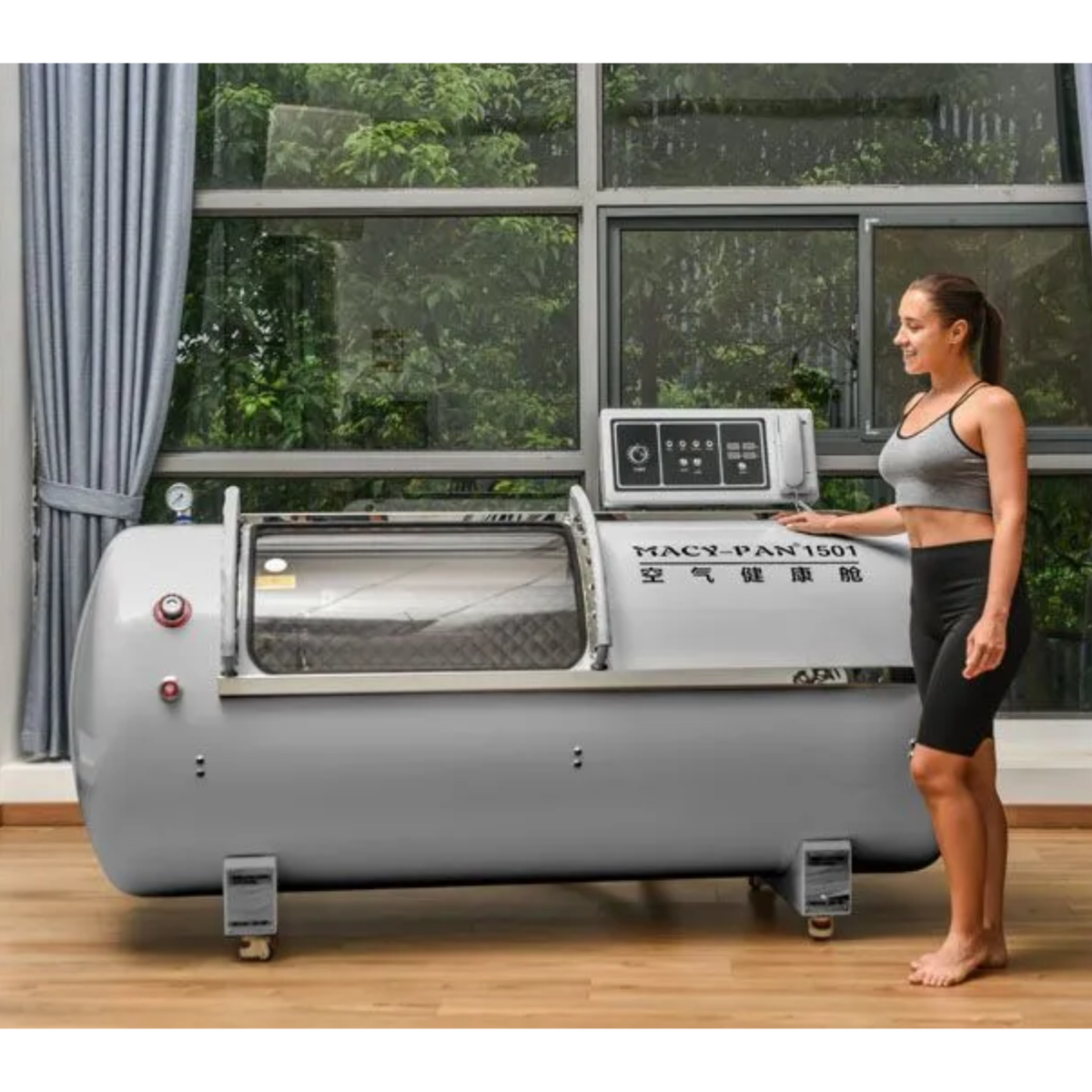 Macy-Pan HP1501 Hard-Shell Lying Hyperbaric Chamber – woman standing next to the gray chamber
