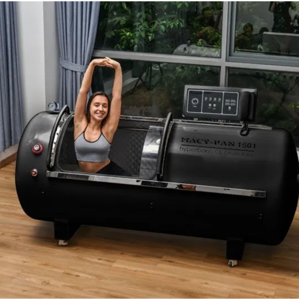 Macy-Pan HP1501 Hard-Shell Lying Hyperbaric Chamber – woman stretching inside the black chamber