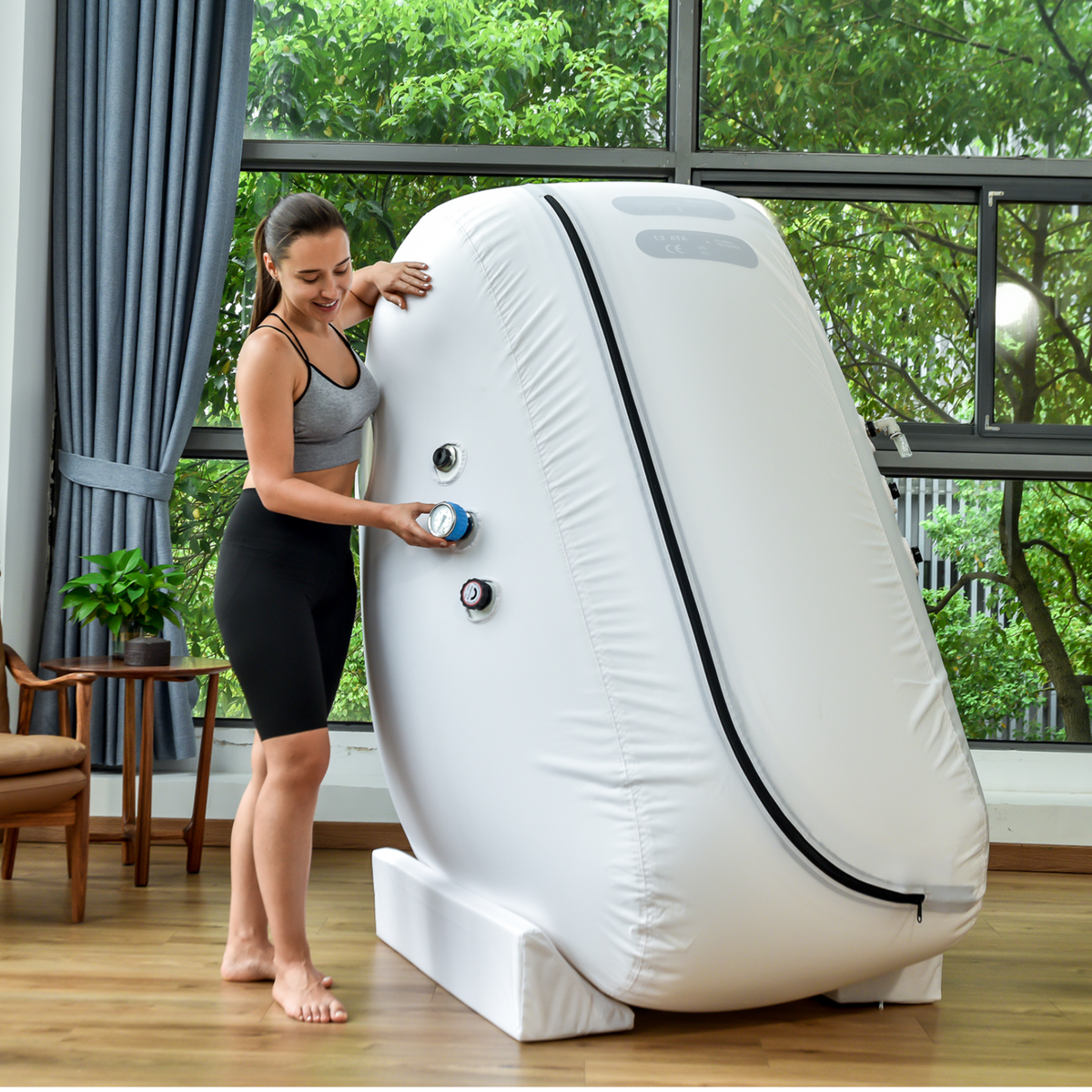 Macy-Pan L1 Sitting Hyperbaric Chamber – woman adjusting the chamber valve