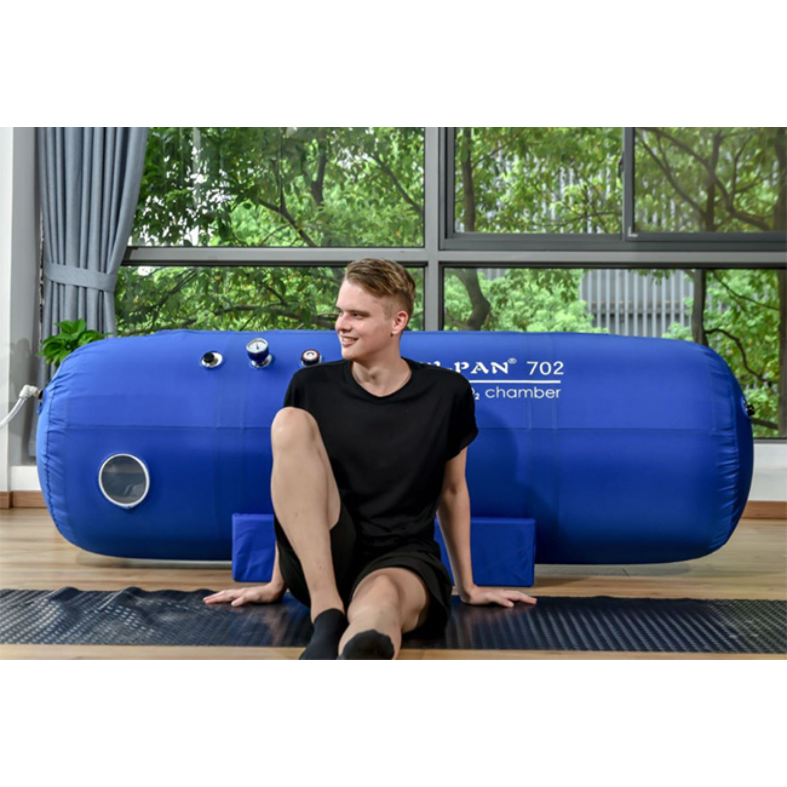 Macy-Pan ST702 Soft Lying Hyperbaric Chamber – man sitting by the chamber