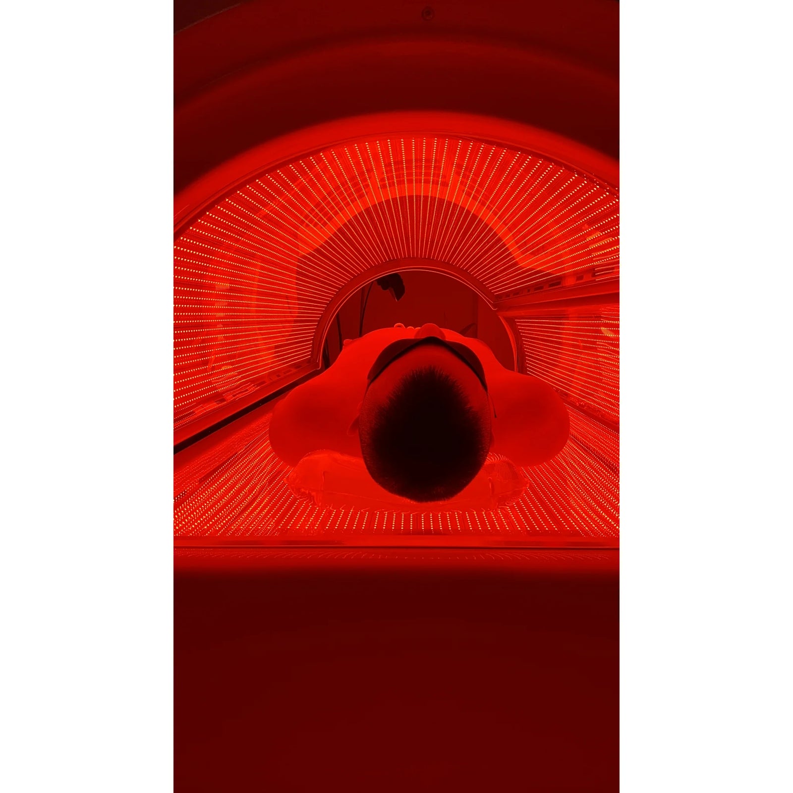 Merican M6N Plus Whole-Body Red Light Therapy Bed – person lying inside the bed under red light