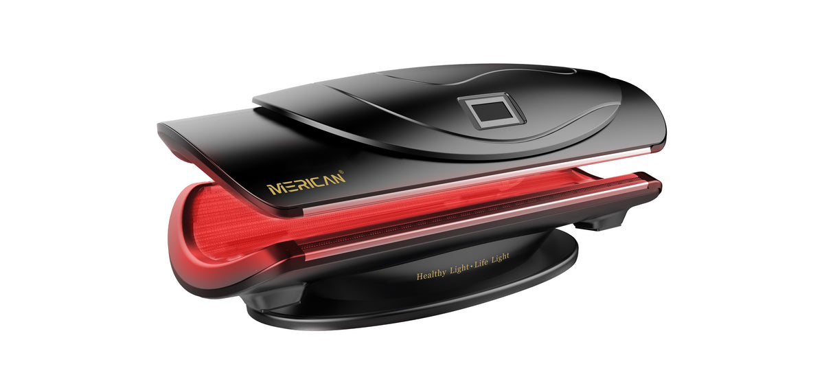 Merican MMB Plus whole-body red light therapy bed in Crystal Black, canopy partly open with red light on, angled view