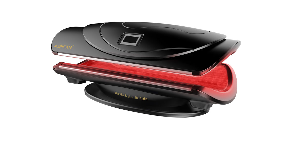 Merican MMB Plus whole-body red light therapy bed in Crystal Black, canopy partly open with red light on, side angled view