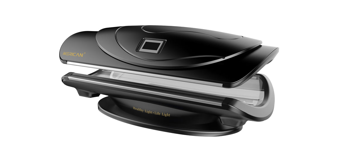 Merican MMB Plus whole-body red light therapy bed in Crystal Black, canopy partly open, wide angled view of the contoured cabin