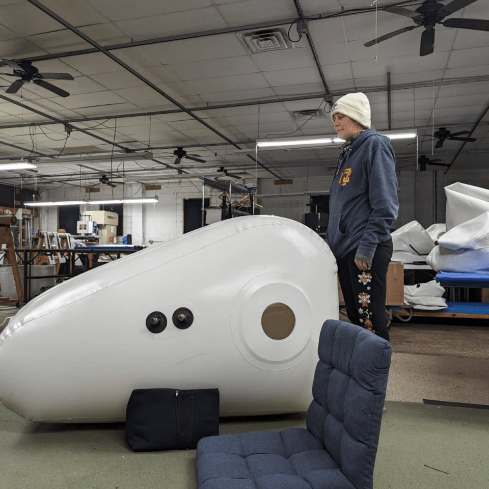 Newtowne C4 Portable Shoe Hyperbaric Chamber – person standing beside the chamber