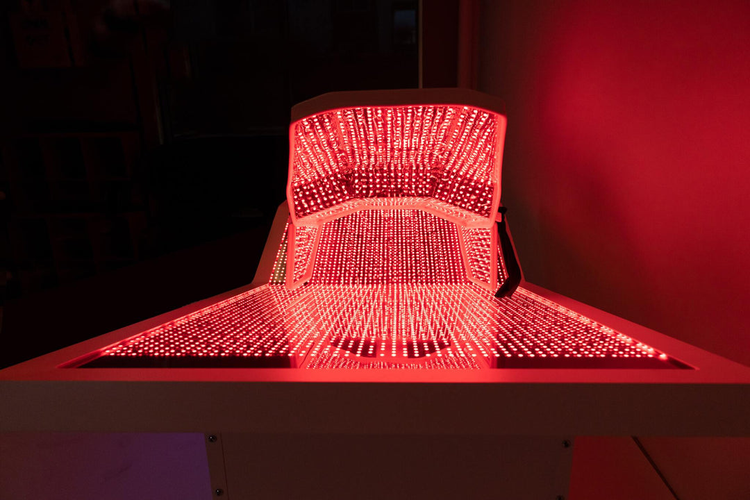Interior view of OvationULT red light therapy bed with LEDs fully illuminated.