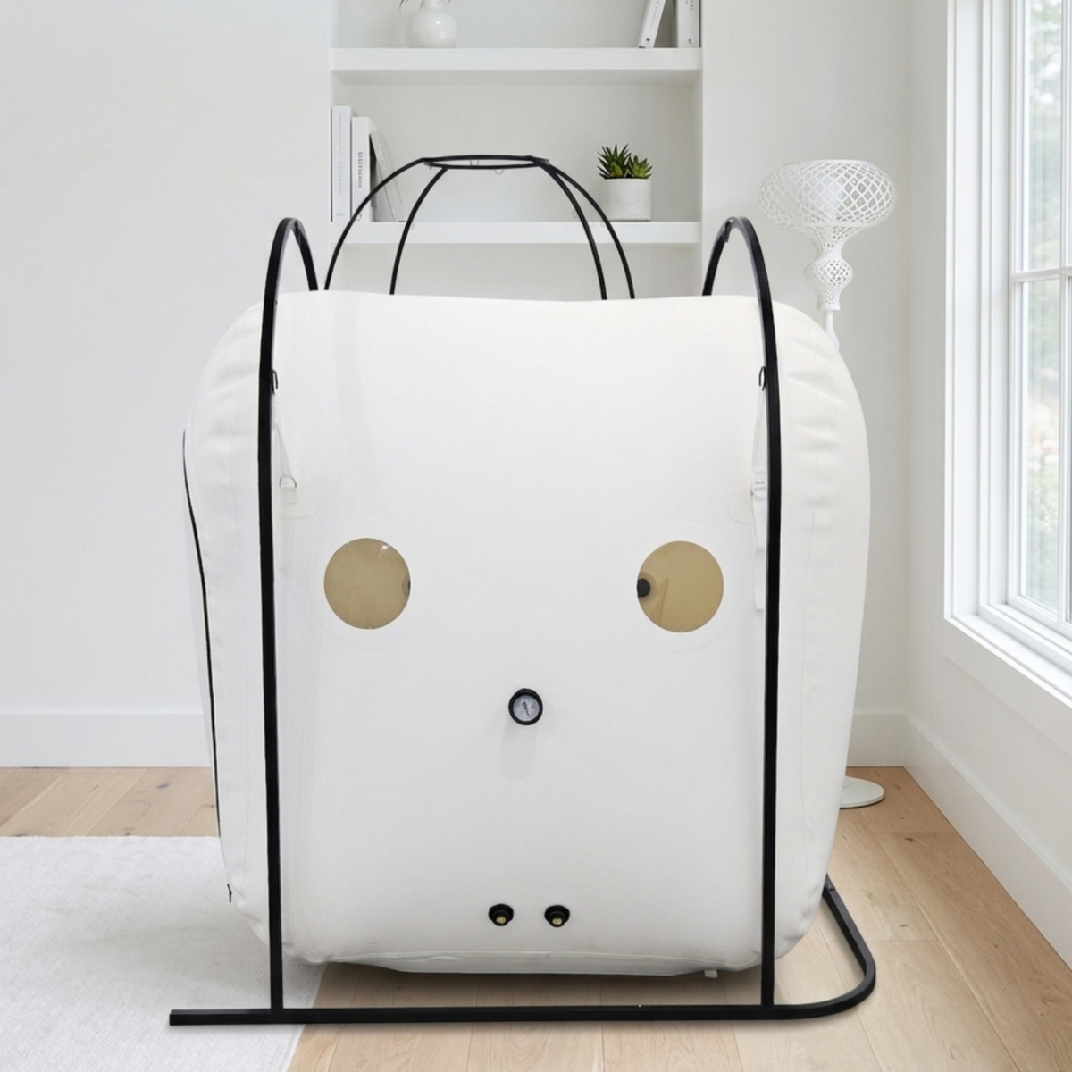 Oxyair OLV-RW01 Wheelchair-Accessible Hyperbaric Chamber – white chamber on a black frame by a window