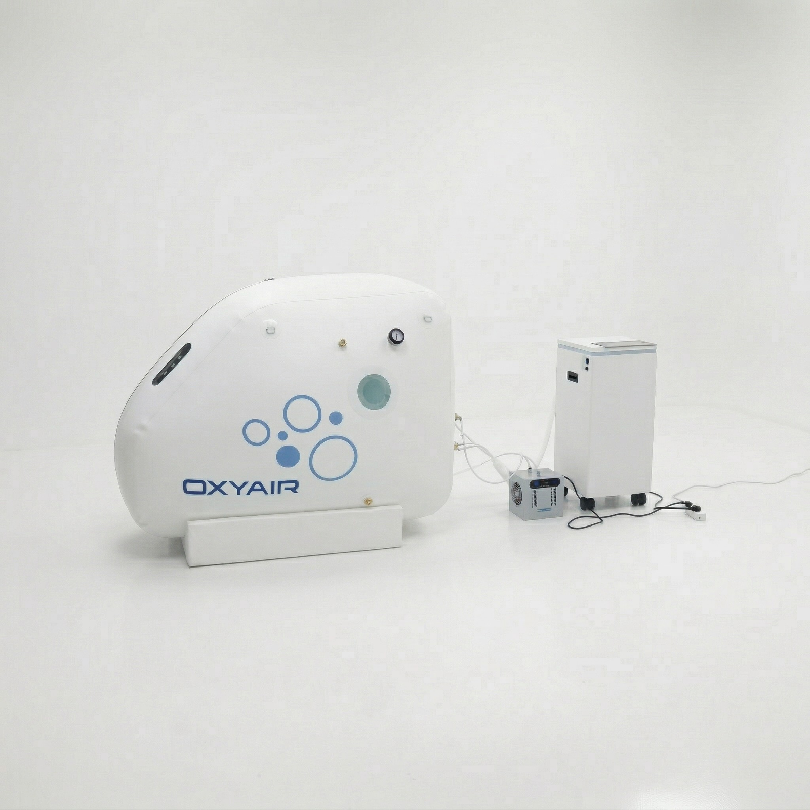 Oxyair OLV-RZ01 Portable Soft Sitting Hyperbaric Chamber – chamber at an angle beside its machine