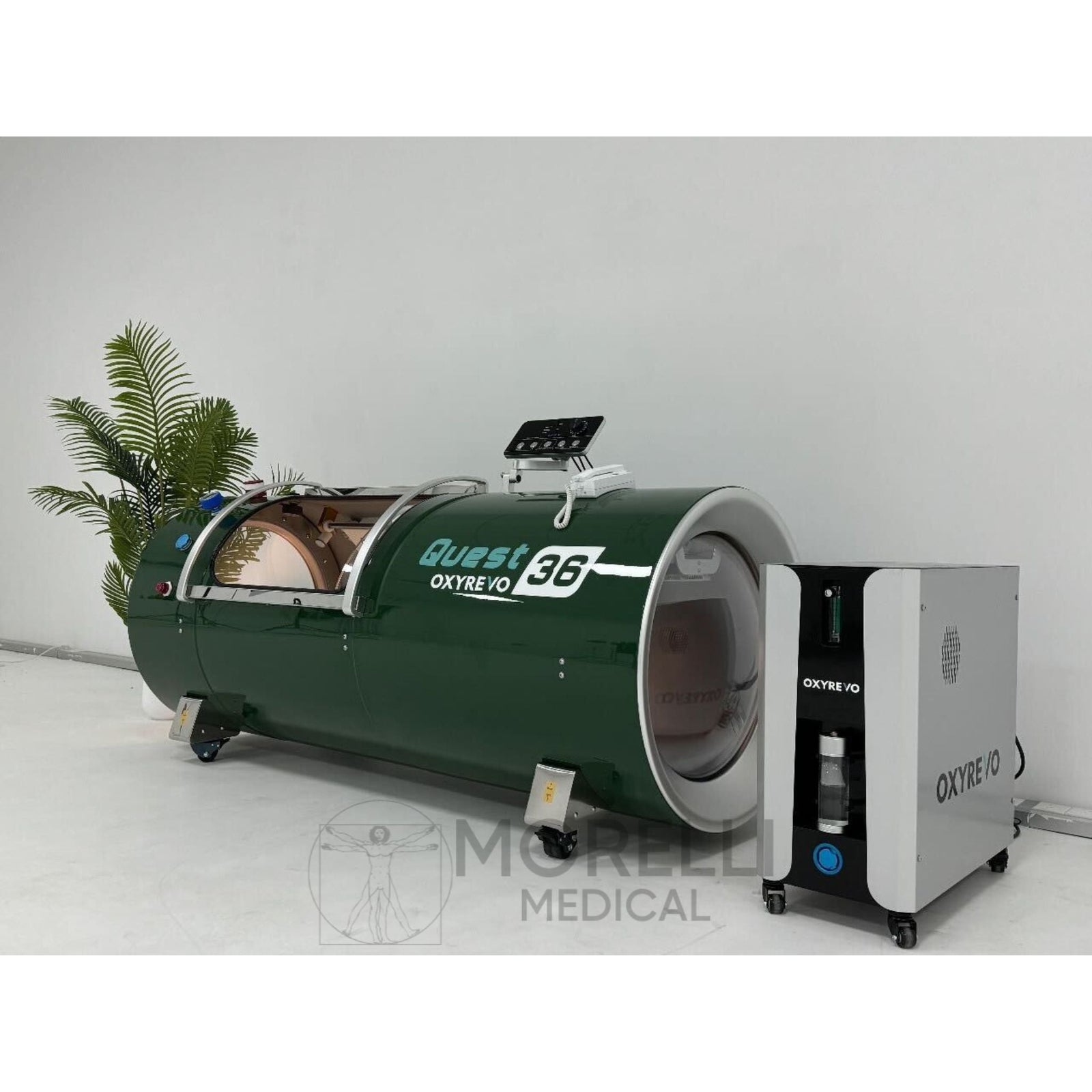 OxyRevo Quest36 Hard-Shell Hyperbaric Chamber – green chamber beside its machine