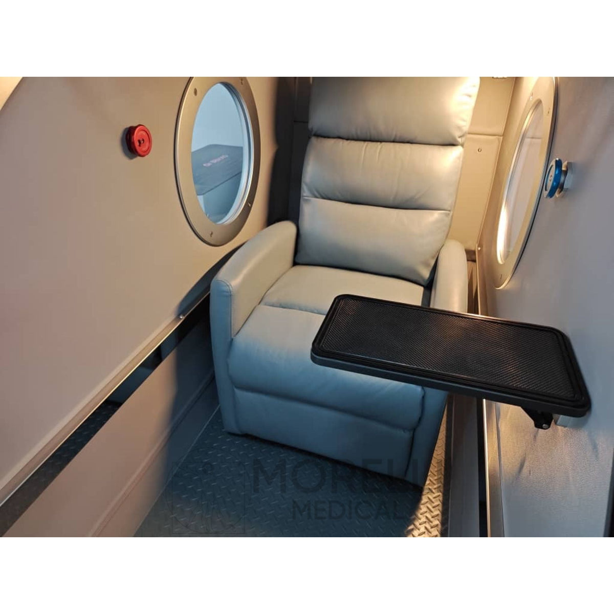 OxyRevo Space60 Hard-Shell Sitting Hyperbaric Chamber – interior with a recliner and table