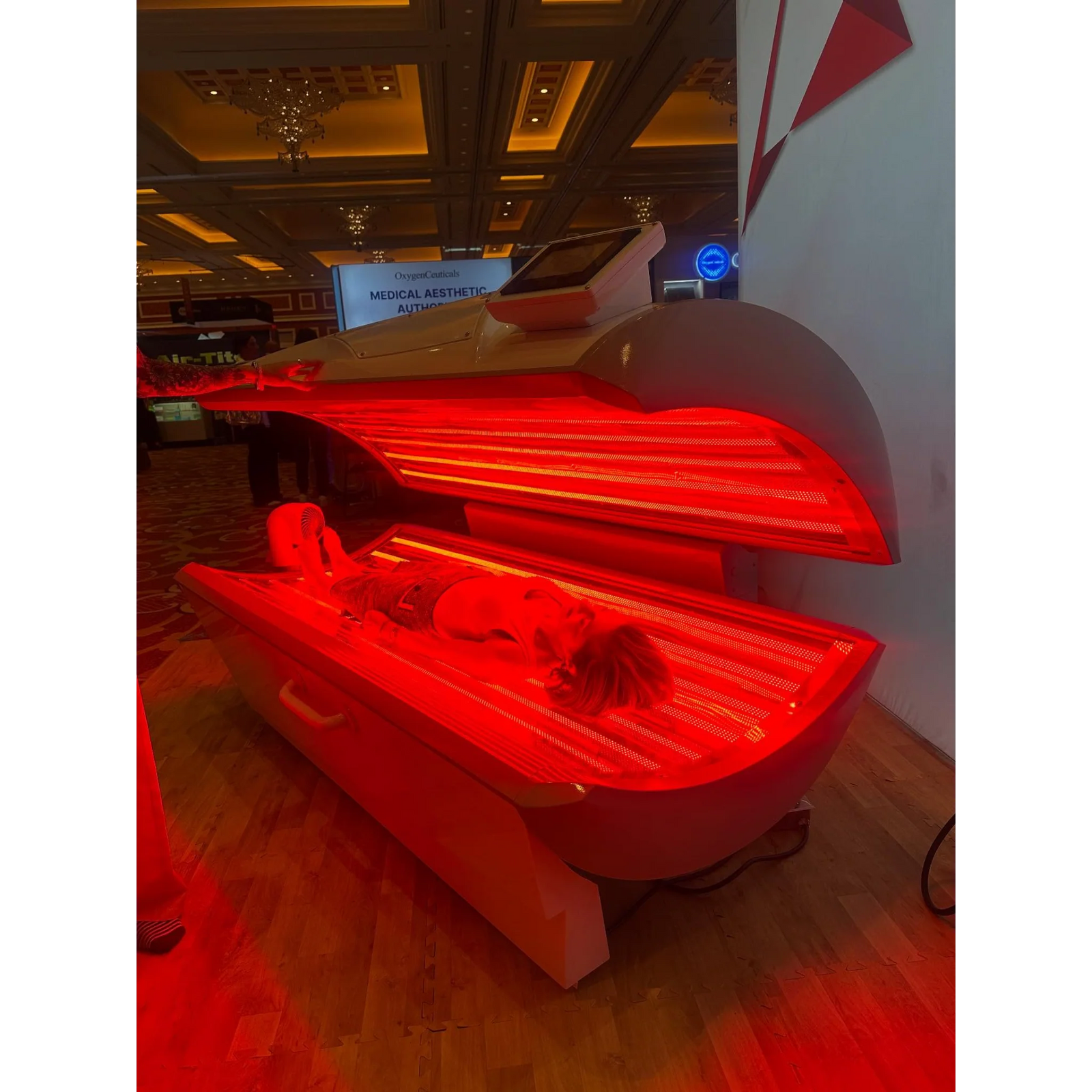 Prism Light Pod Full-Body Red Light Therapy Bed – pod open with red light in a studio
