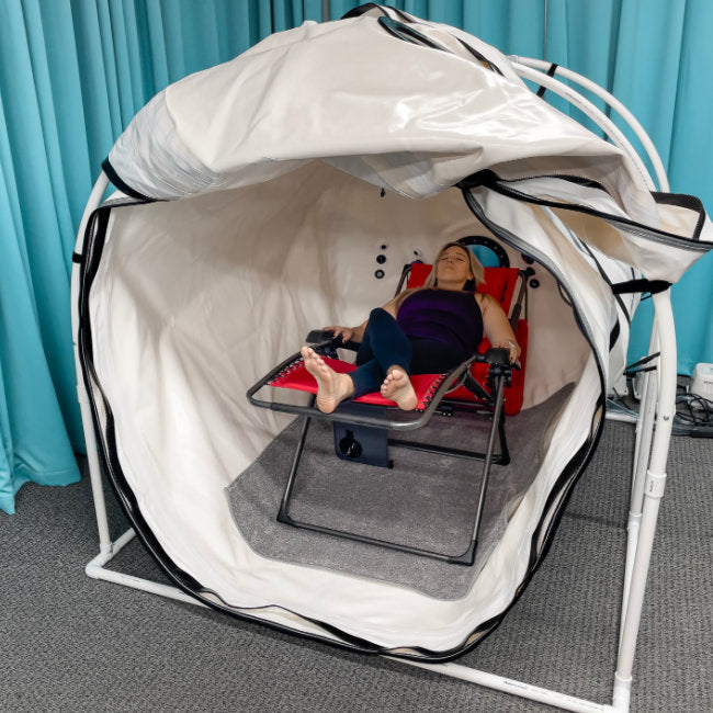 Summit to Sea Grand Dive Pro Plus 60" Hyperbaric Chamber – person reclining in a chair inside