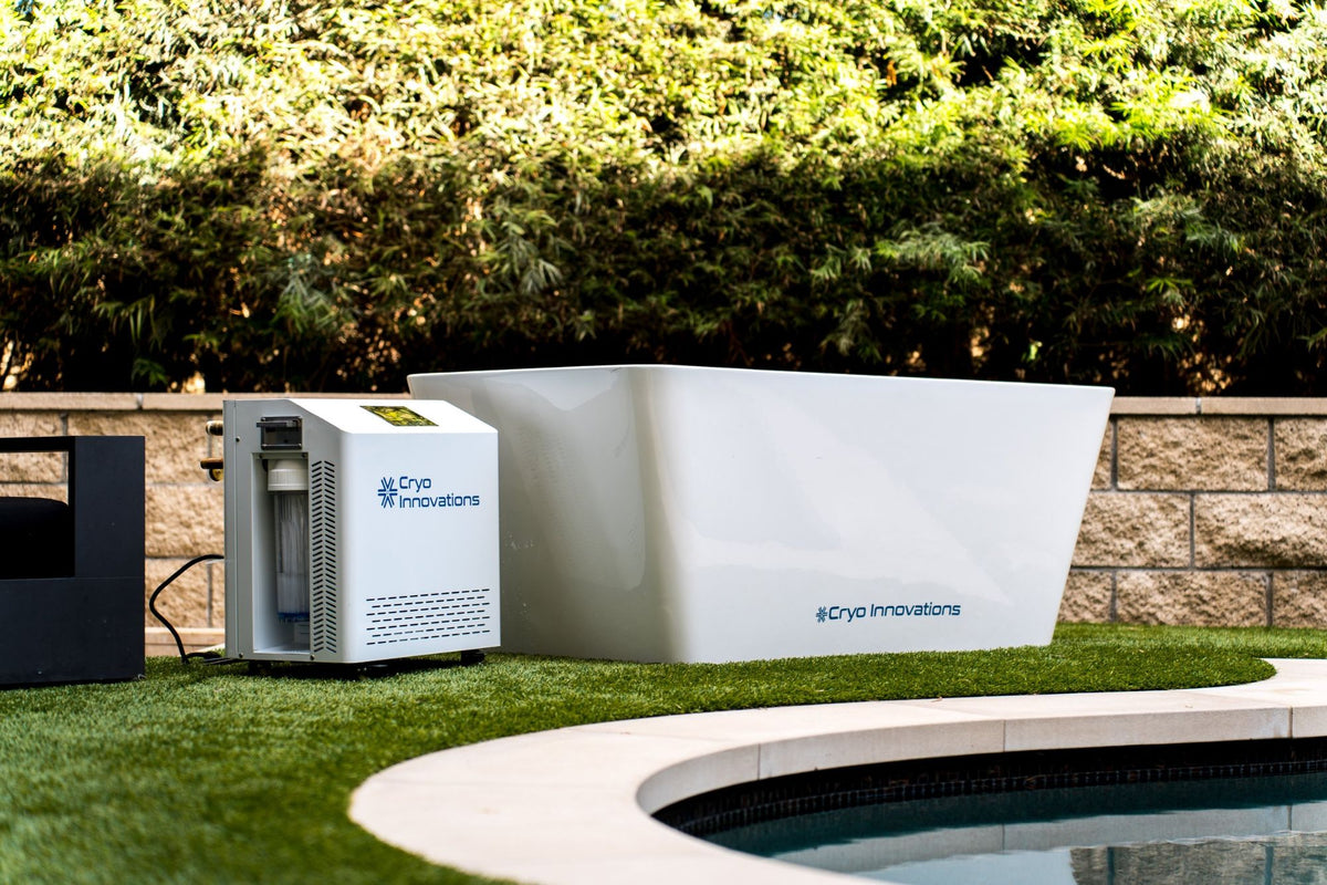 Cryo Innovations XR Cryo Plunge acrylic tub with chiller/heater beside a backyard pool