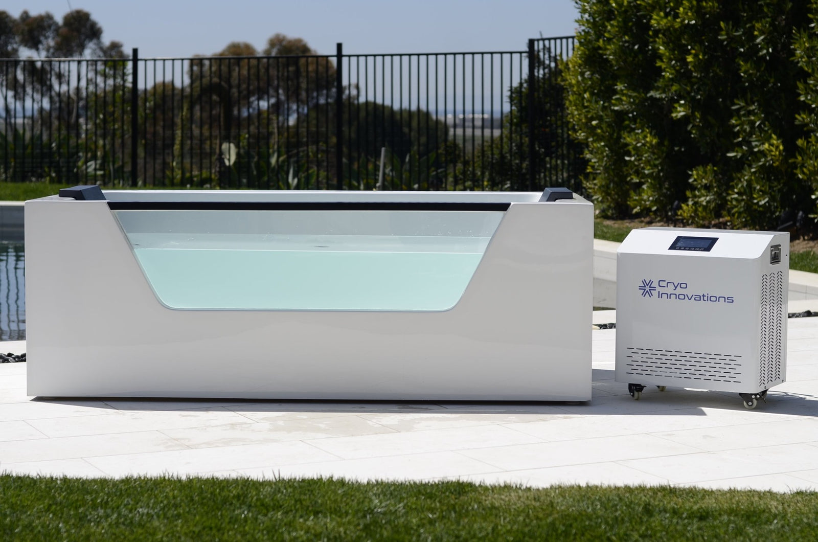 Cryo Innovations XR Cryo Plunge with Window acrylic tub with transparent side window and chiller/heater on a pool patio