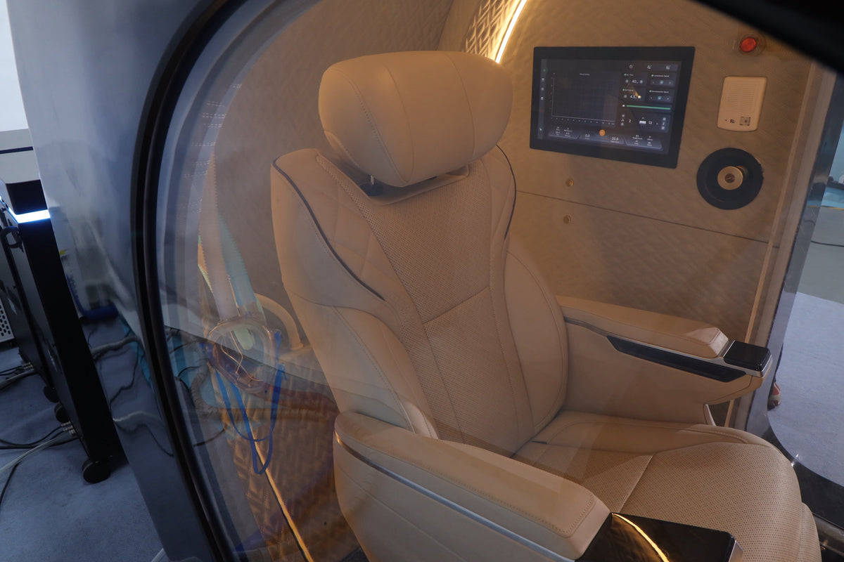 Inside the Oxyair OLV-YZD01: leather seat with headrest, interior touch screen, intercom and accent lighting