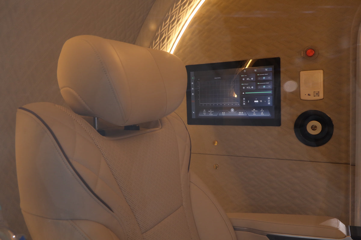 Oxyair OLV-YZD01 interior touch screen showing session controls and readouts, beside the leather seat headrest